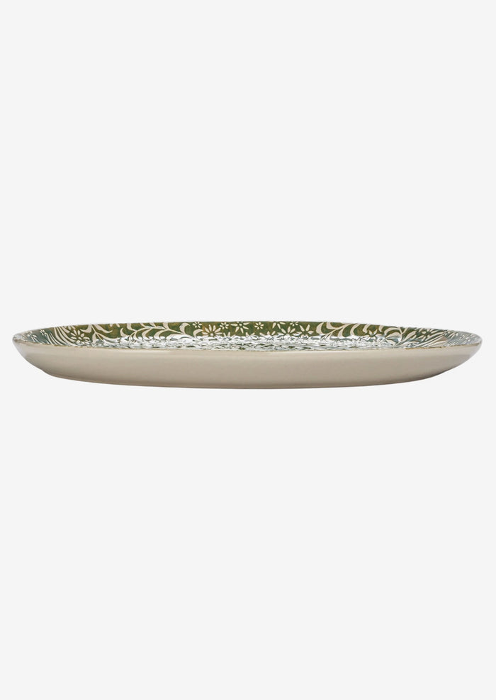 An oval shaped ceramic tray in green with botanical wax relief pattern.