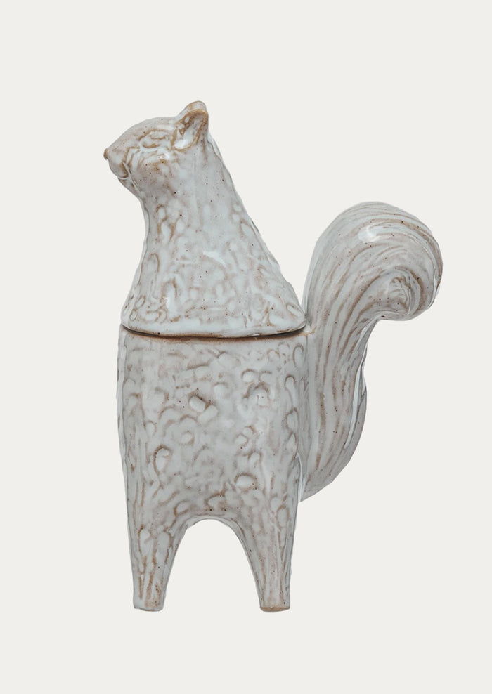 A ceramic jar in the shape of a squirrel standing on two legs.