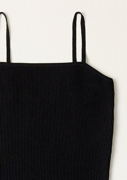 A black spaghetti strap dress with fitted bodice.