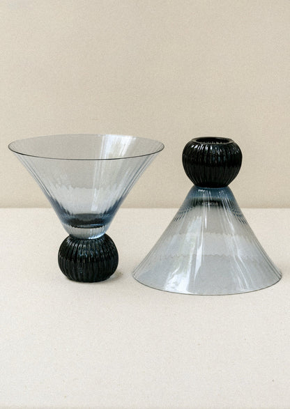 Two short blue glass martini glasses with ribbed, flared shape.