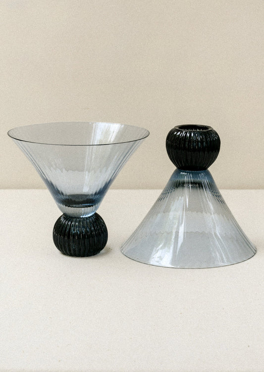Two short blue glass martini glasses with ribbed, flared shape.