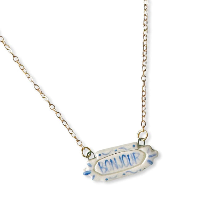 Crown & Heart zz.Bonjour pendant necklace with a delicate gold chain and a charming Bonjour pendant, stylish jewelry accessory.