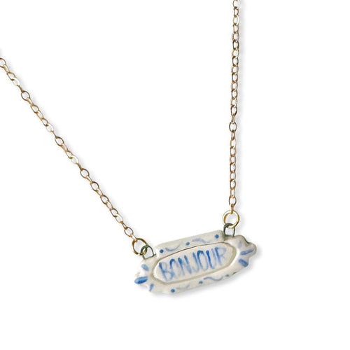 Crown & Heart zz.Bonjour pendant necklace with a delicate gold chain and a charming Bonjour pendant, stylish jewelry accessory.
