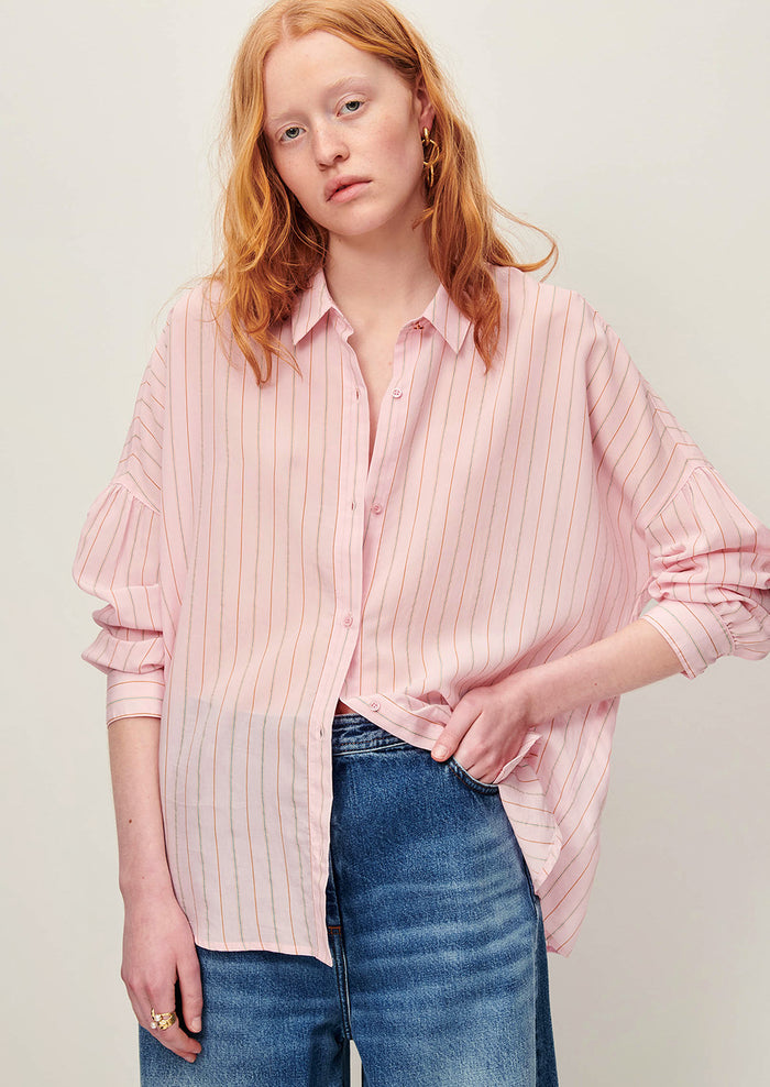 A button front shirt in pink with fine multicolor pinstripe pattern.