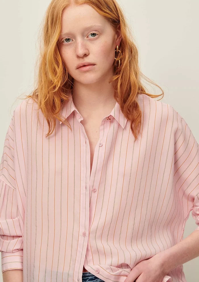 A button front shirt in pink with fine multicolor pinstripe pattern.
