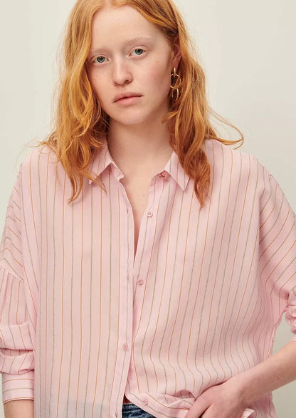A button front shirt in pink with fine multicolor pinstripe pattern.