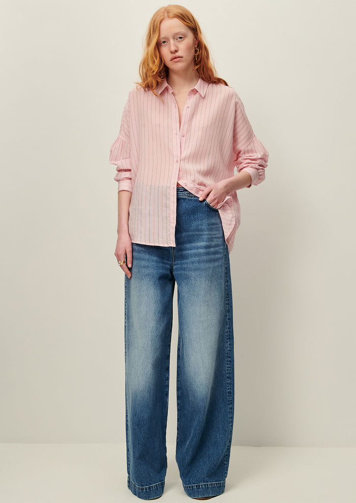 A button front shirt in pink with fine multicolor pinstripe pattern.