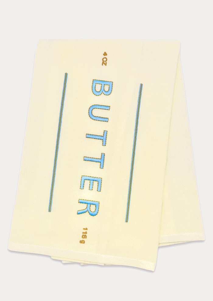 A yellow tea towel resembling a stick of butter.