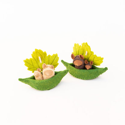Fairy Shadow Critters in Leaf Sailboat, both colorways displayed side by side against a white background, showing the beige mice set on the left with two cream-colored felt mouse critters in a green felt leaf boat with a yellow-green maple leaf sail, and the chocolate mice set on the right with two dark brown felt mouse critters in an identical boat