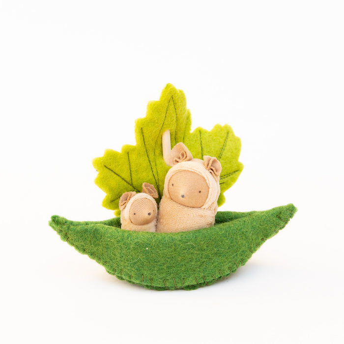 Fairy Shadow Critters in Leaf Sailboat in beige mice, product view against white background, showing a large cream-colored felt mouse critter and a small cream-colored felt mouse critter sitting together in a curved green felt leaf boat, with a hand-embroidered yellow-green felt maple leaf as the sail