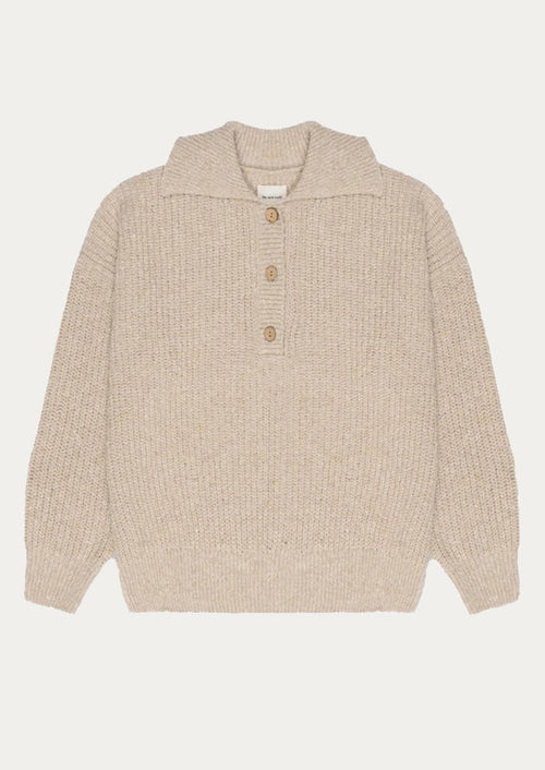 Beige knitted sweater with button details on a white background