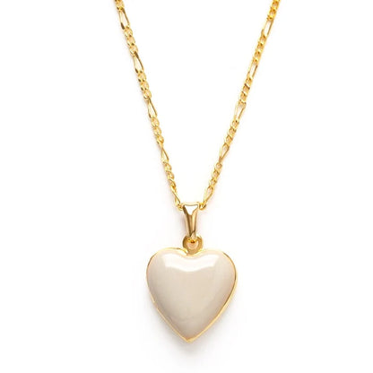 A beige heart-shaped locket on a gold-colored chain.