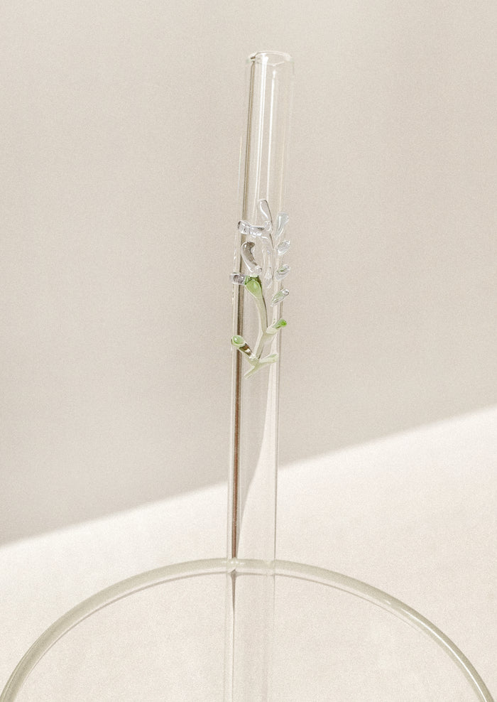 Clear glass straw with bent shape, with lampwork lavender figurine.