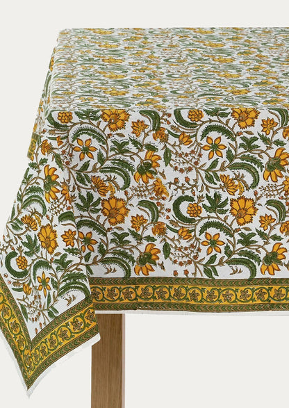 A block printed tablecloth in yellow and green floral pattern.