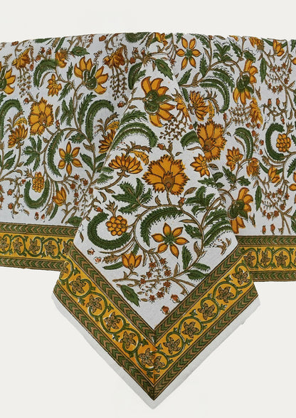 A block printed tablecloth in yellow and green floral pattern.