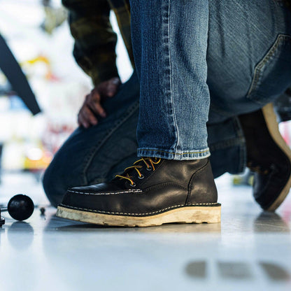 Danner Bull Run 6-inch steel toe work boot in black, shown worn in a lifestyle setting