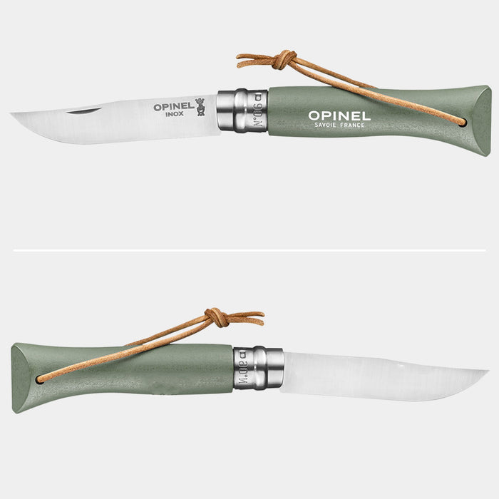Opinel No.6 Colorama pocket knife shown from two angles — blade side and spine side — with sage green handle and leather lanyard, knife open