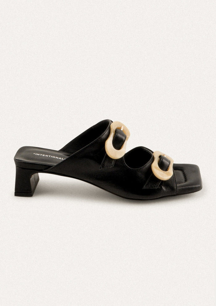 A square toe heeled sandal in black with double tan buckle detail.