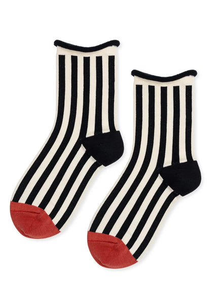 Black and white striped socks with red toes on a white background