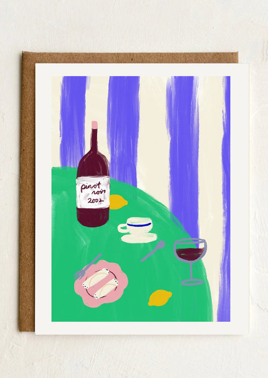 A greeting card with illustration of a bottle of wine on a table.