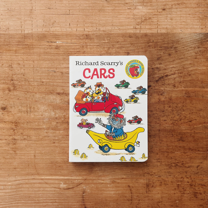 Cover of Richard Scarry's Cars board book featuring illustrated animal characters driving a red car and a yellow banana mobile, with colorful racing cars scattered across a white background