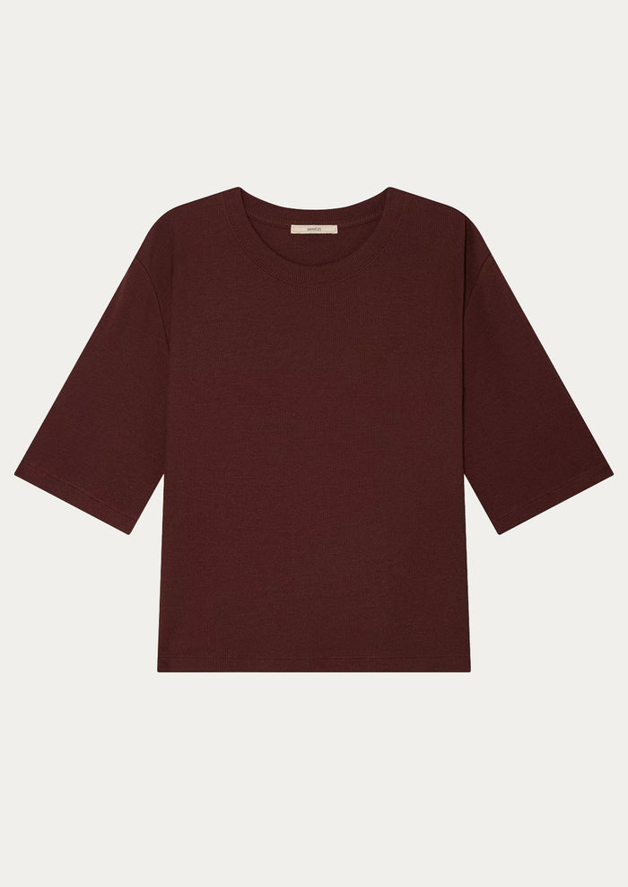 A t-shirt with half length sleeve in burgundy.