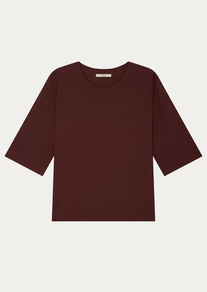 A t-shirt with half length sleeve in burgundy.