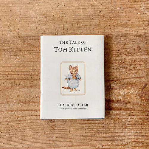 tale of tom kitten cover shot top view laydown on wooden background