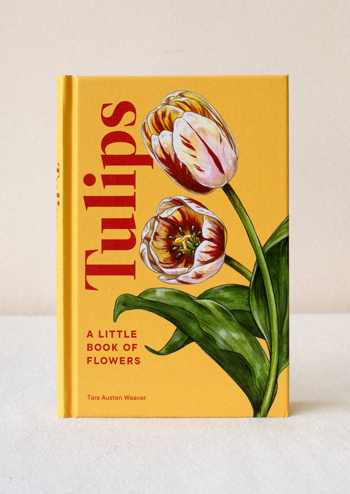 A small hardcover book in yellow titled "Tulips".